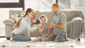 A joyful family enjoying quality time and coffee in a bright living room, symbolizing love and togetherness.